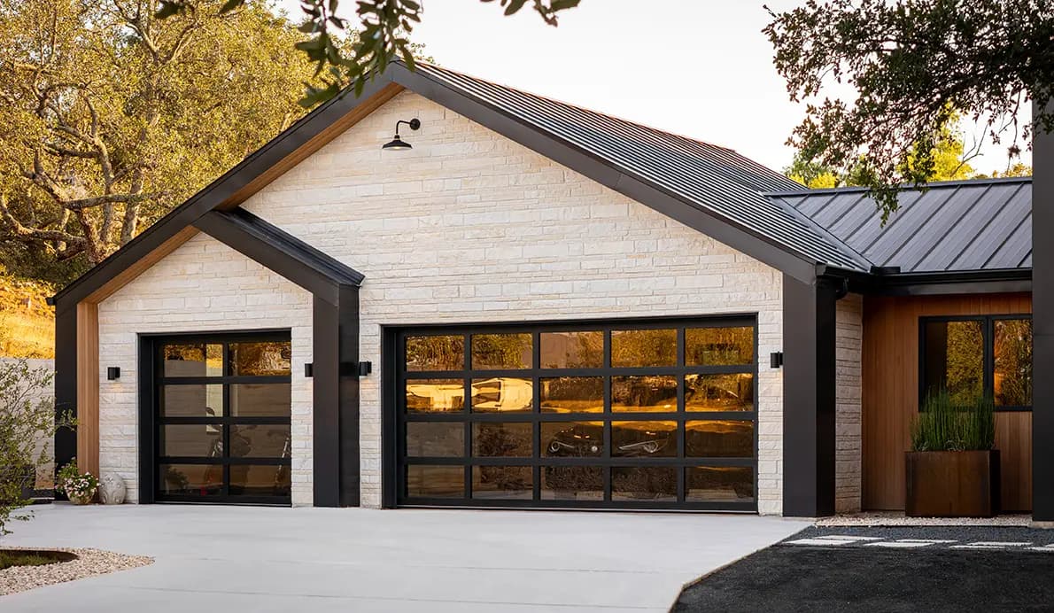 Modern home with stylish glass garage doors